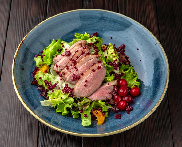 Salad with smoked duck, cranberries and pomegranate caviar