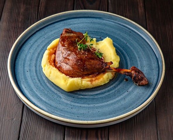 Duck leg confit with mashed potatoes and sauce Noilly Prat