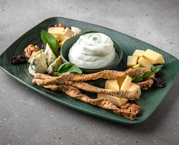 Cheese plate with sour cherries and walnuts
