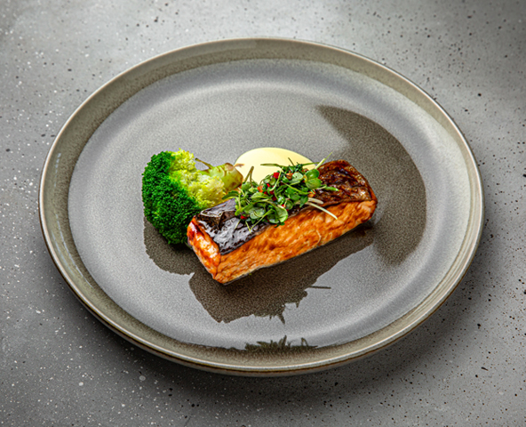 Grilled salmon steak with broccoli,microgreen salad and creamy orange sauce