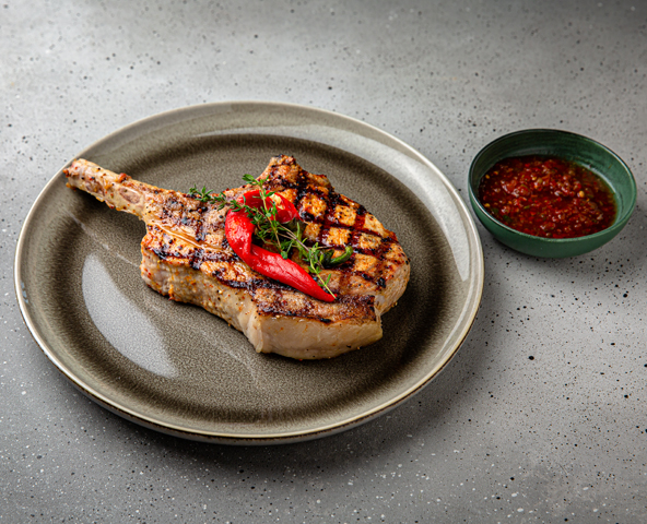 Grilled pork chop with spicy sauce