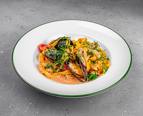 Tagliatelle with seafood in creamy tomato sauce